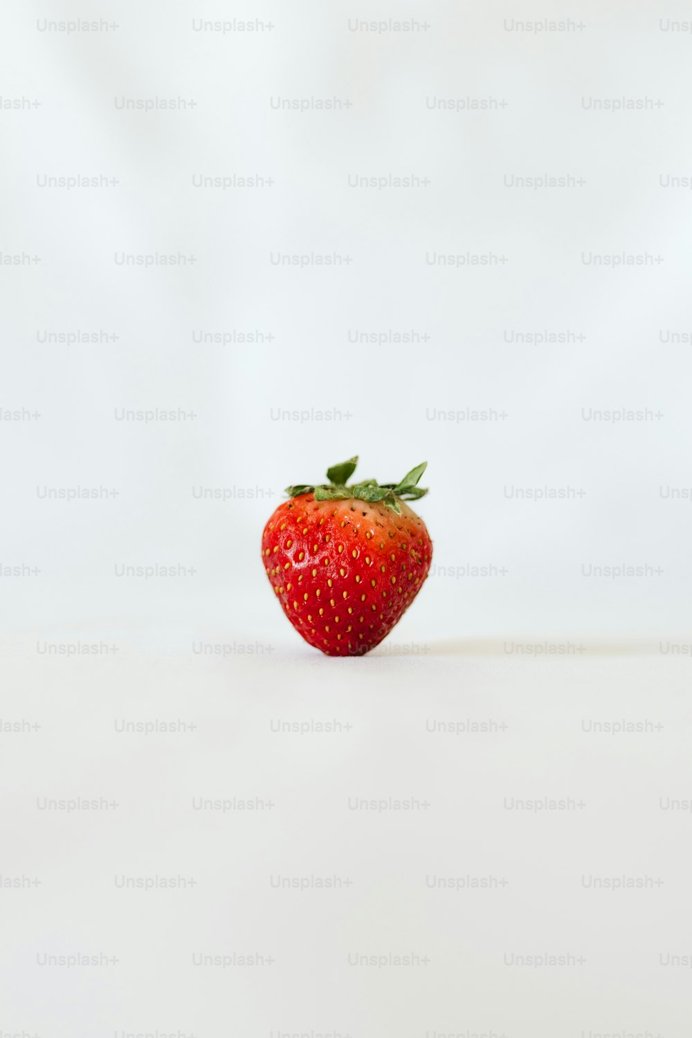 a red strawberry with green leaves