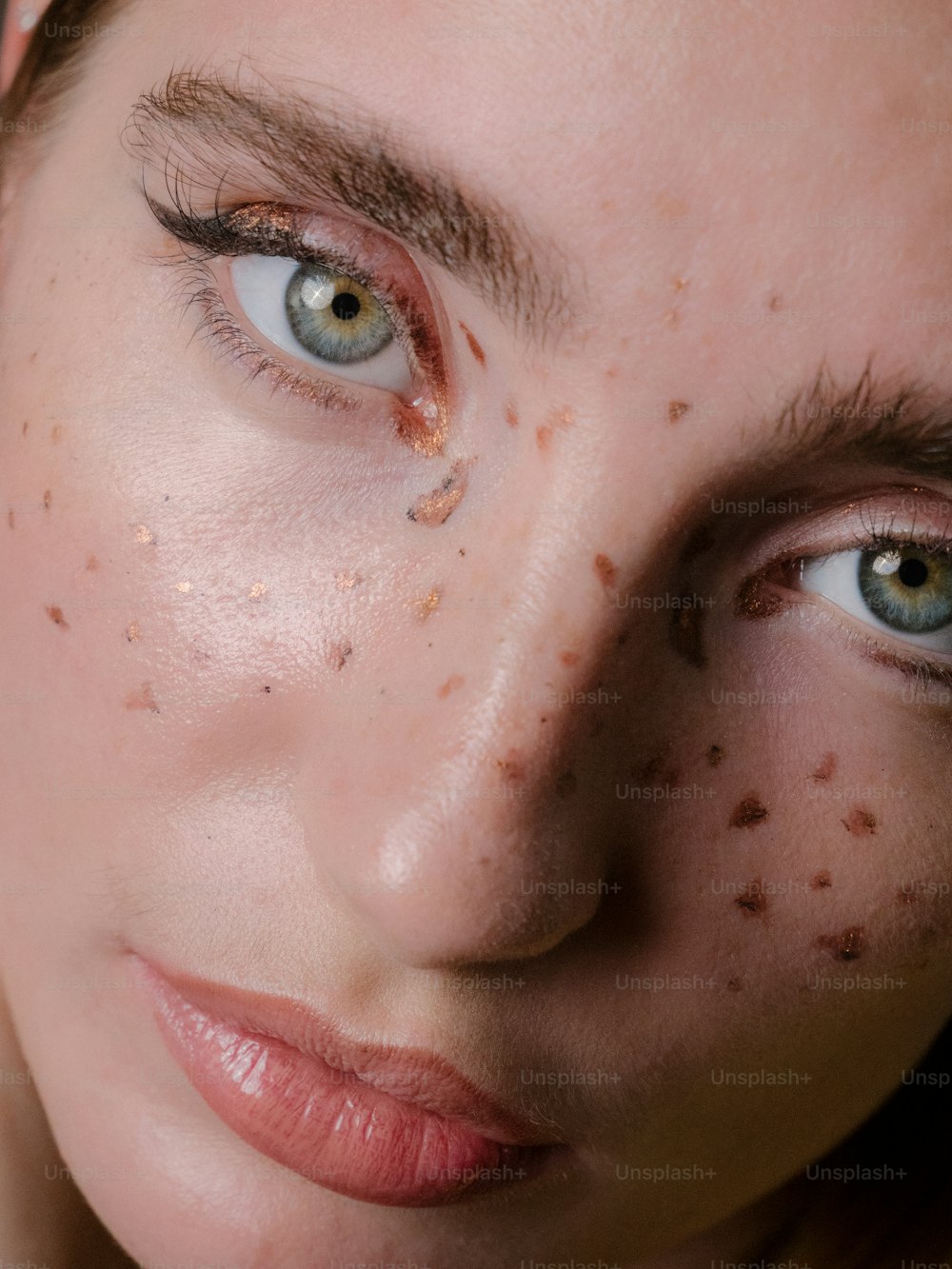 a close up of a woman with freckles on her face