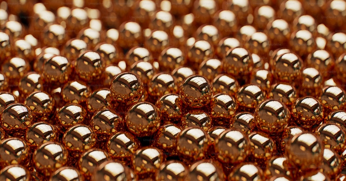 A close up of a pile of gold coins photo – Bead Image on Unsplash