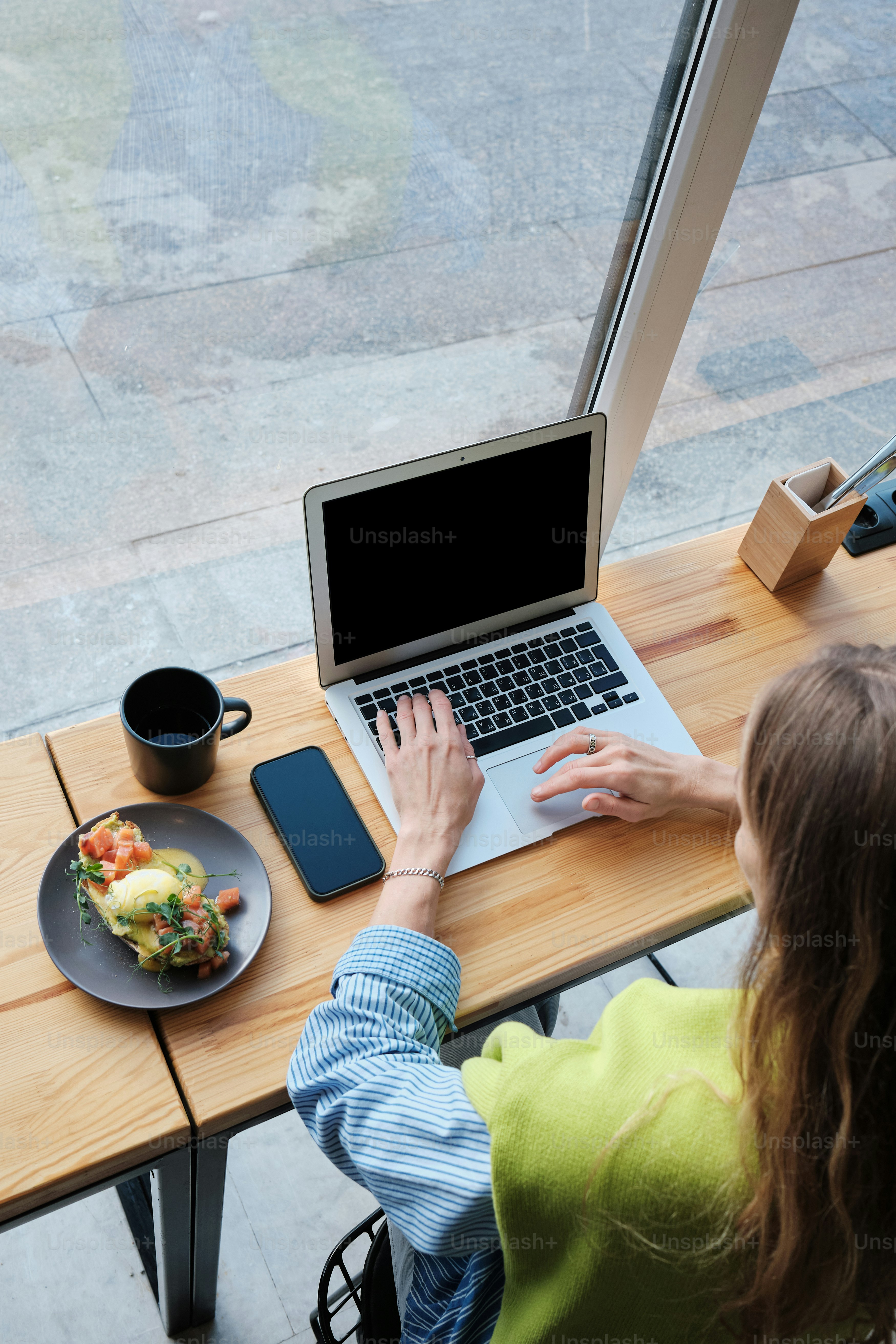 a woman and a child sitting at a table with a laptop