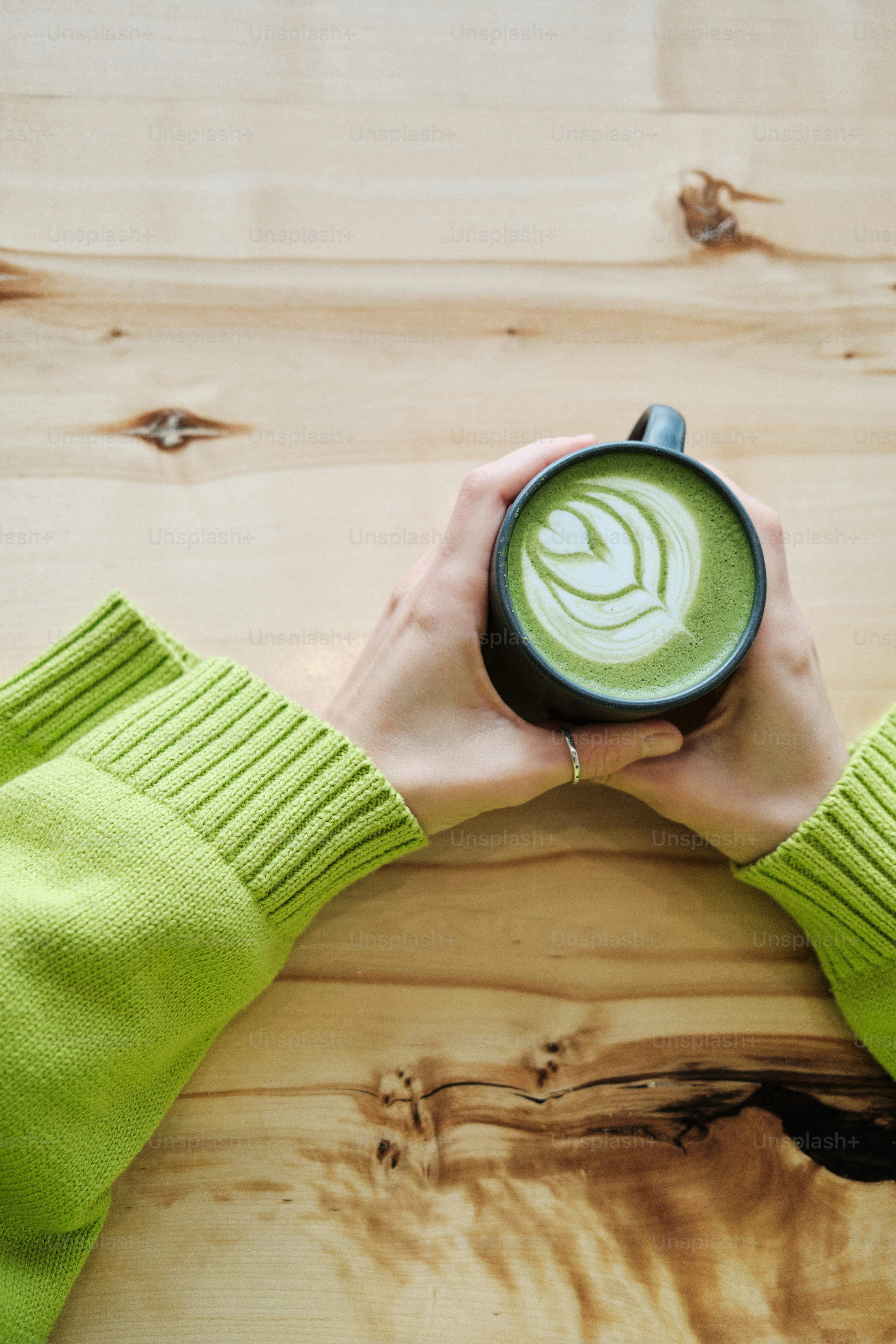 a person holding a green cup