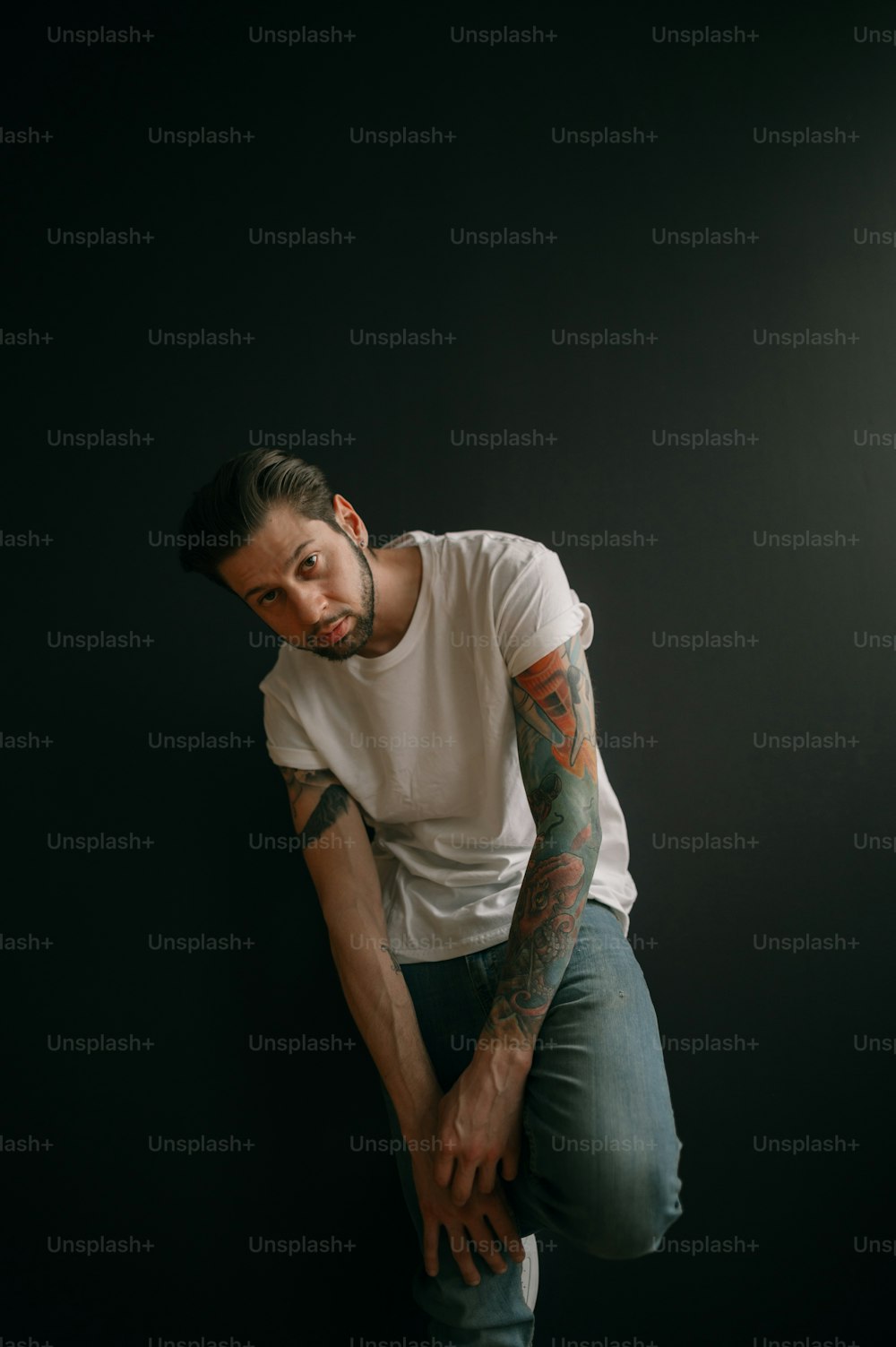 a man with tattoos posing for the camera
