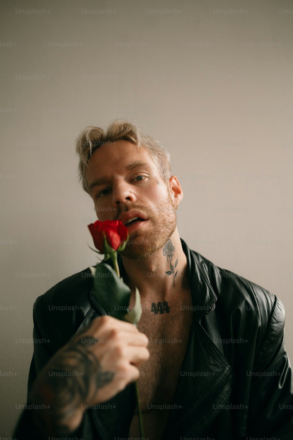 a man with a rose in his mouth