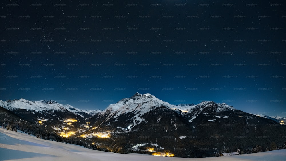 a snowy mountain range at night
