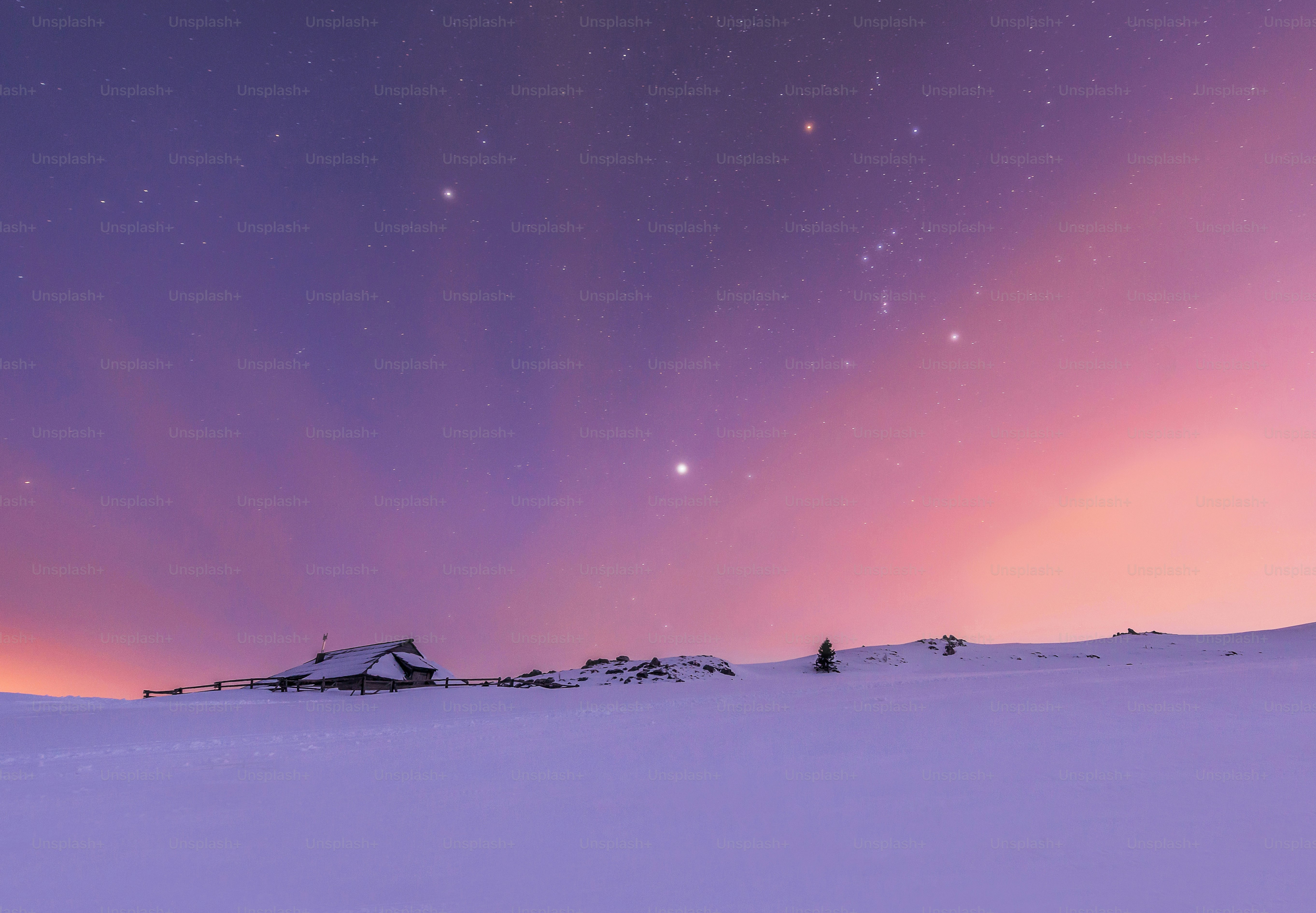 a snowy landscape with a purple sky