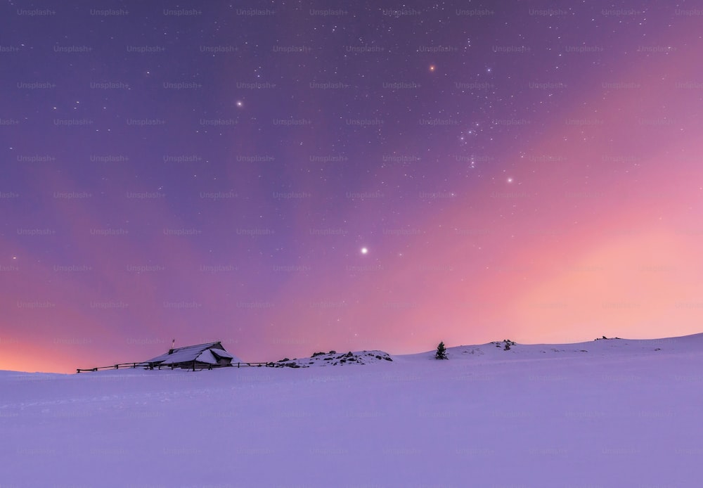 a snowy landscape with a purple sky