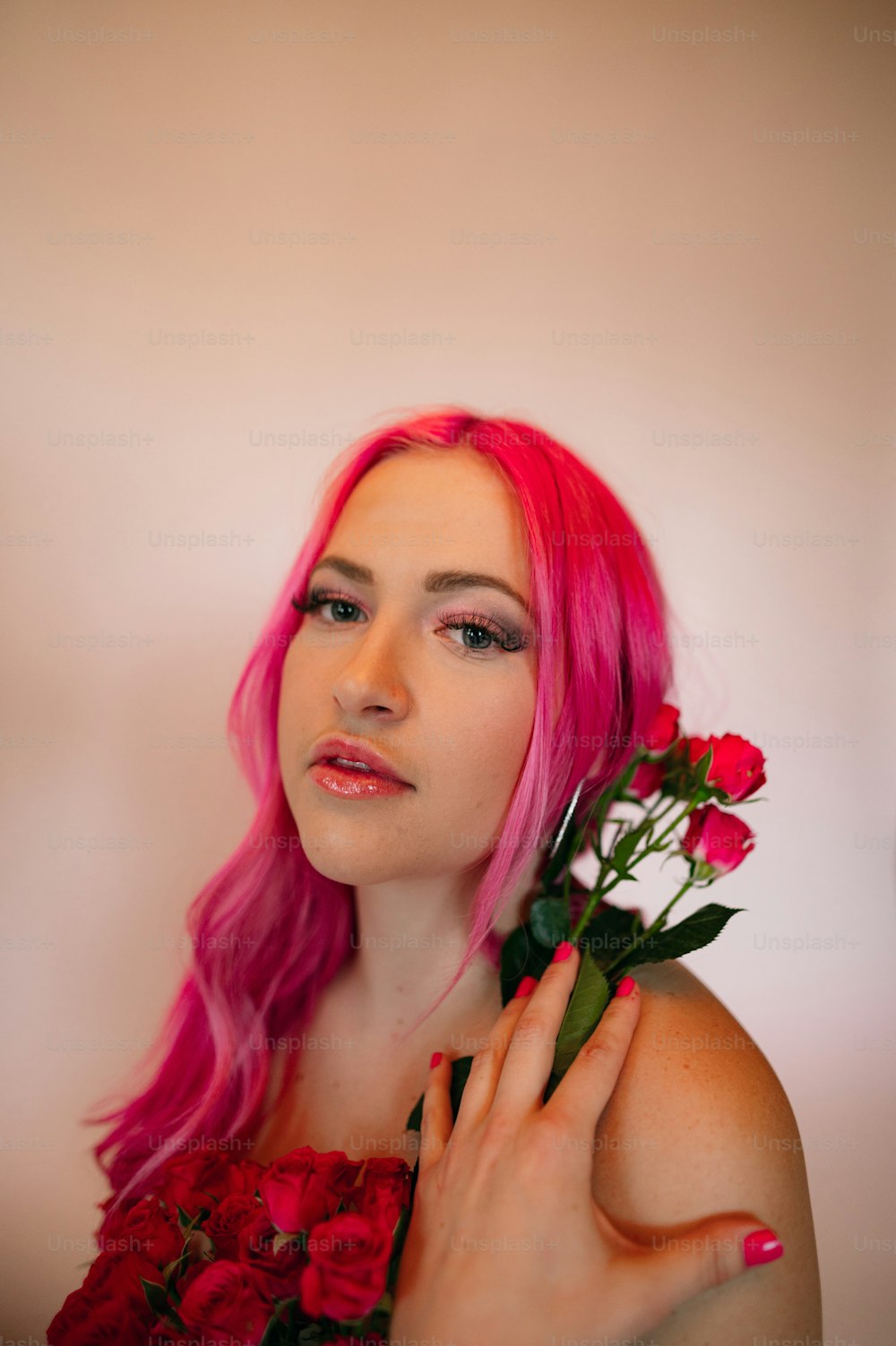 a woman with pink hair holding flowers