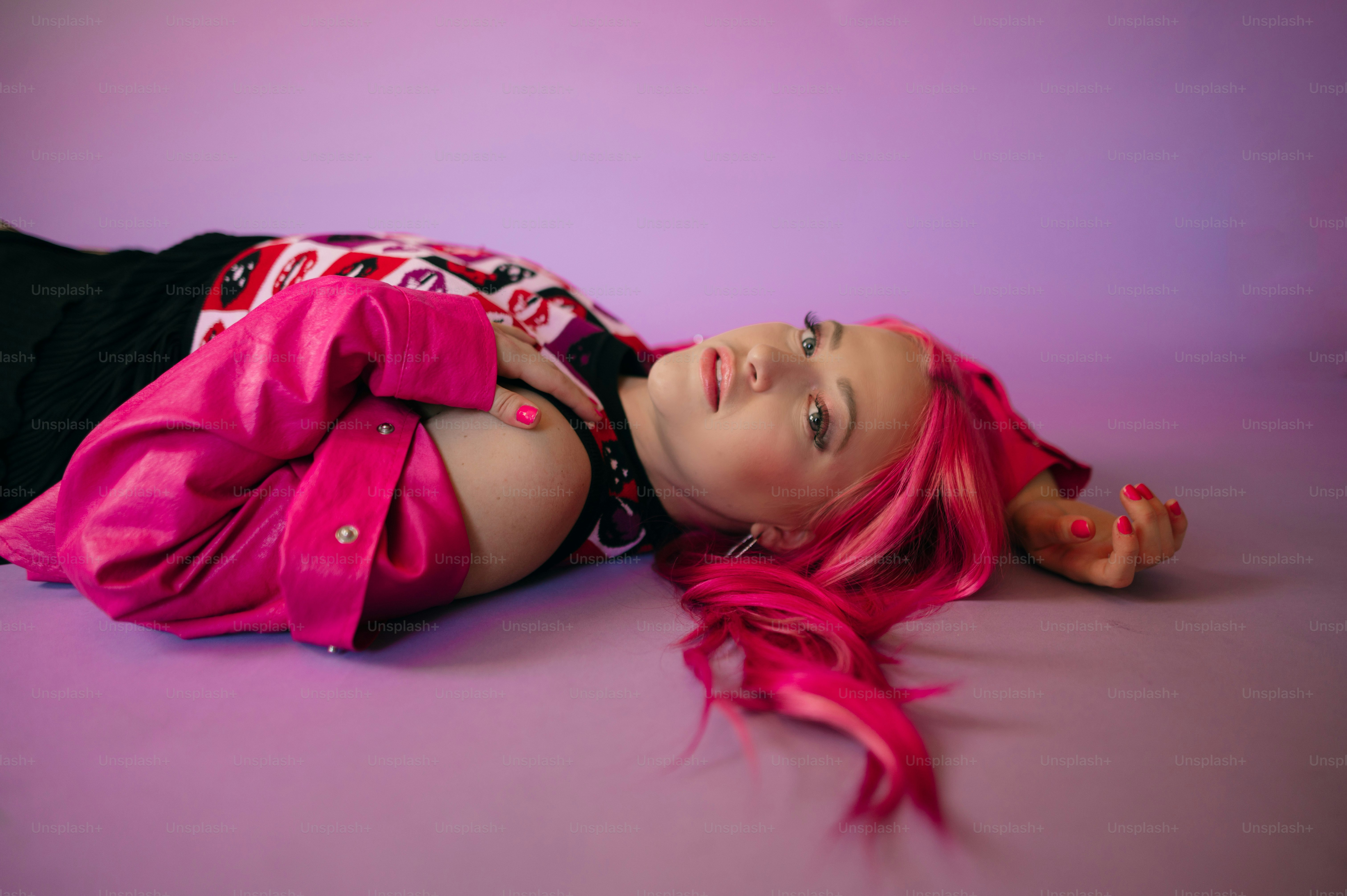 a person wearing a red dress and smiling at the camera