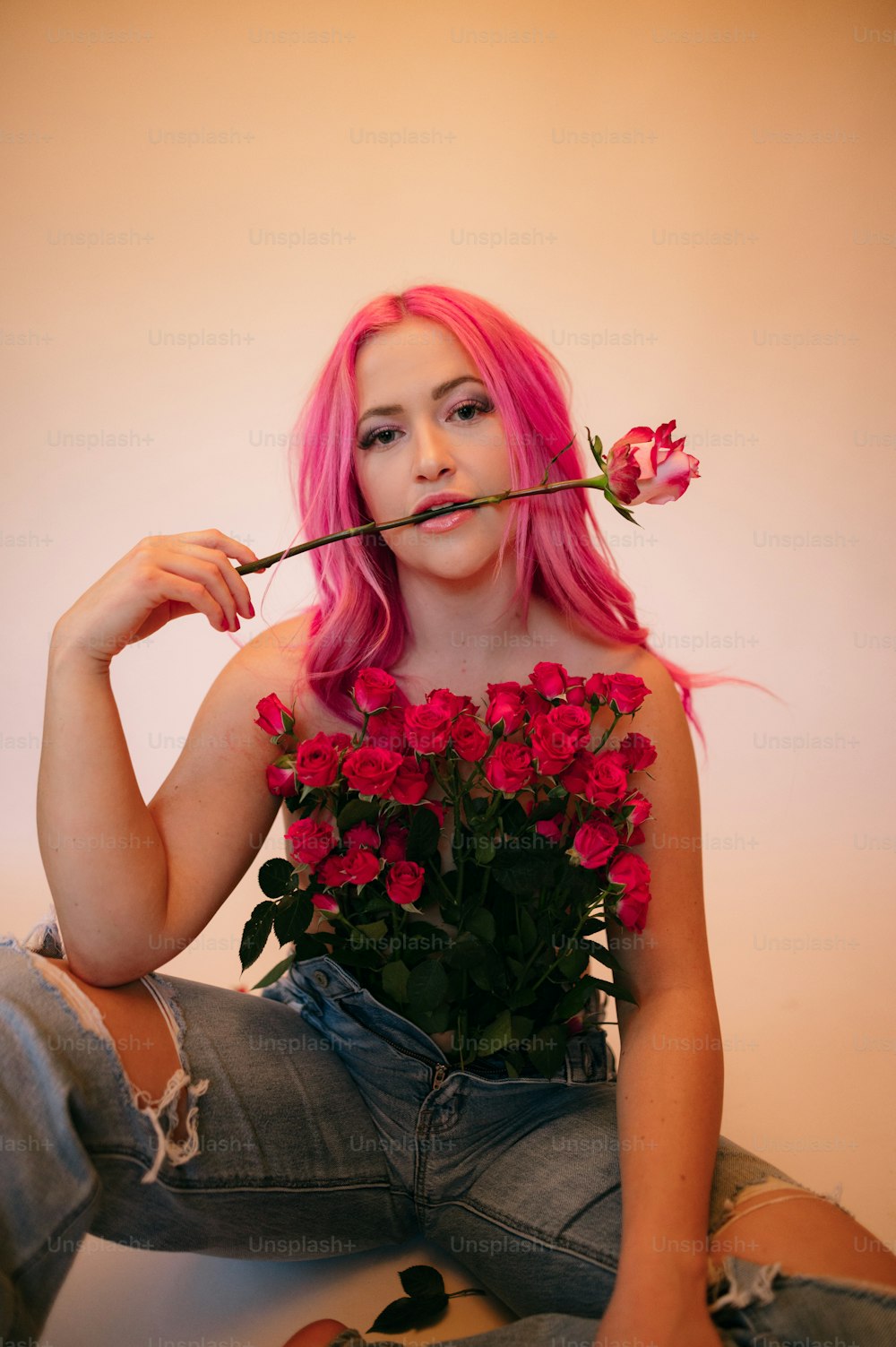 a woman with pink hair holding flowers