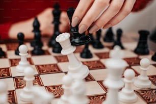 a hand playing chess