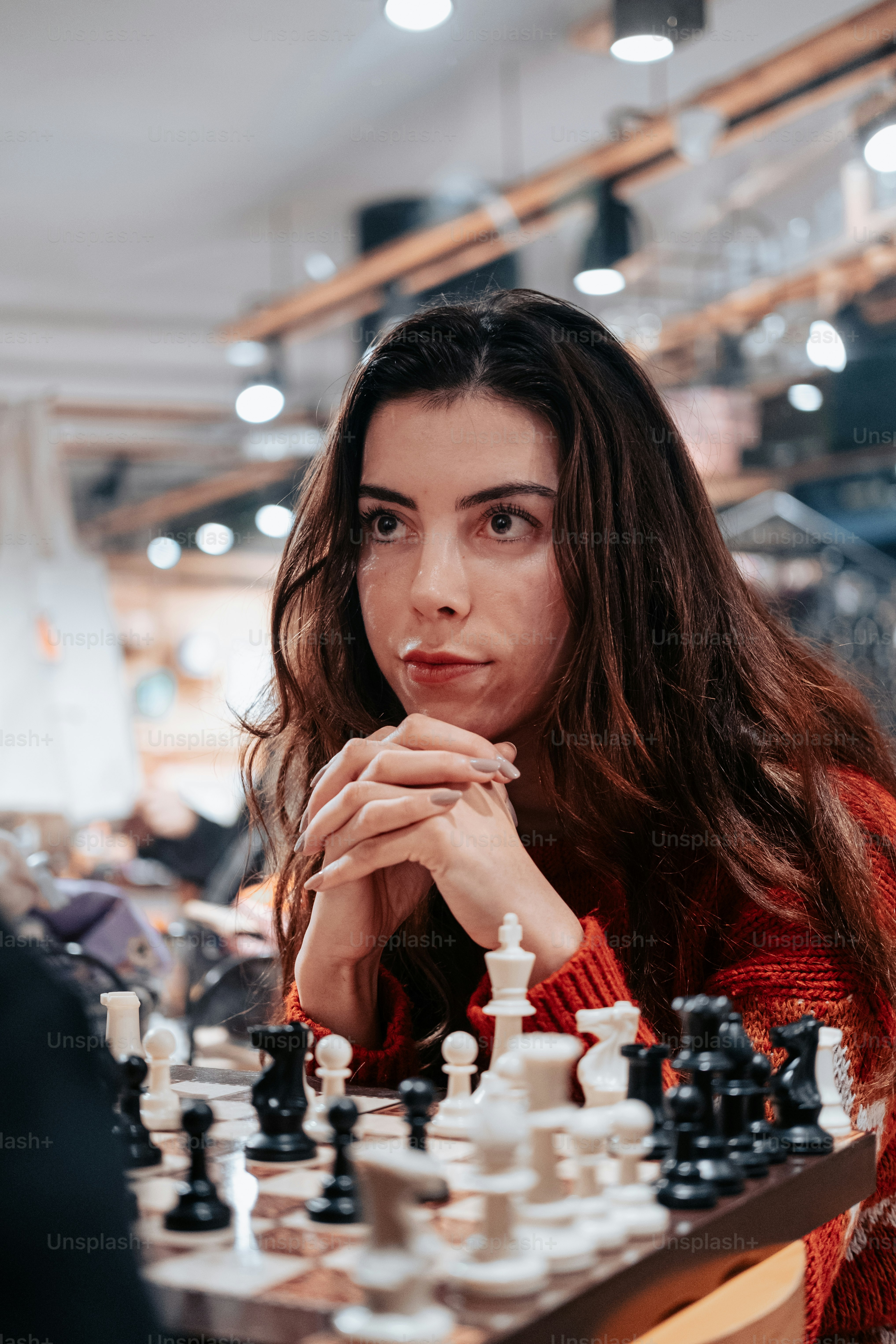 A woman sitting at a chess board photo – Chess Image on Unsplash