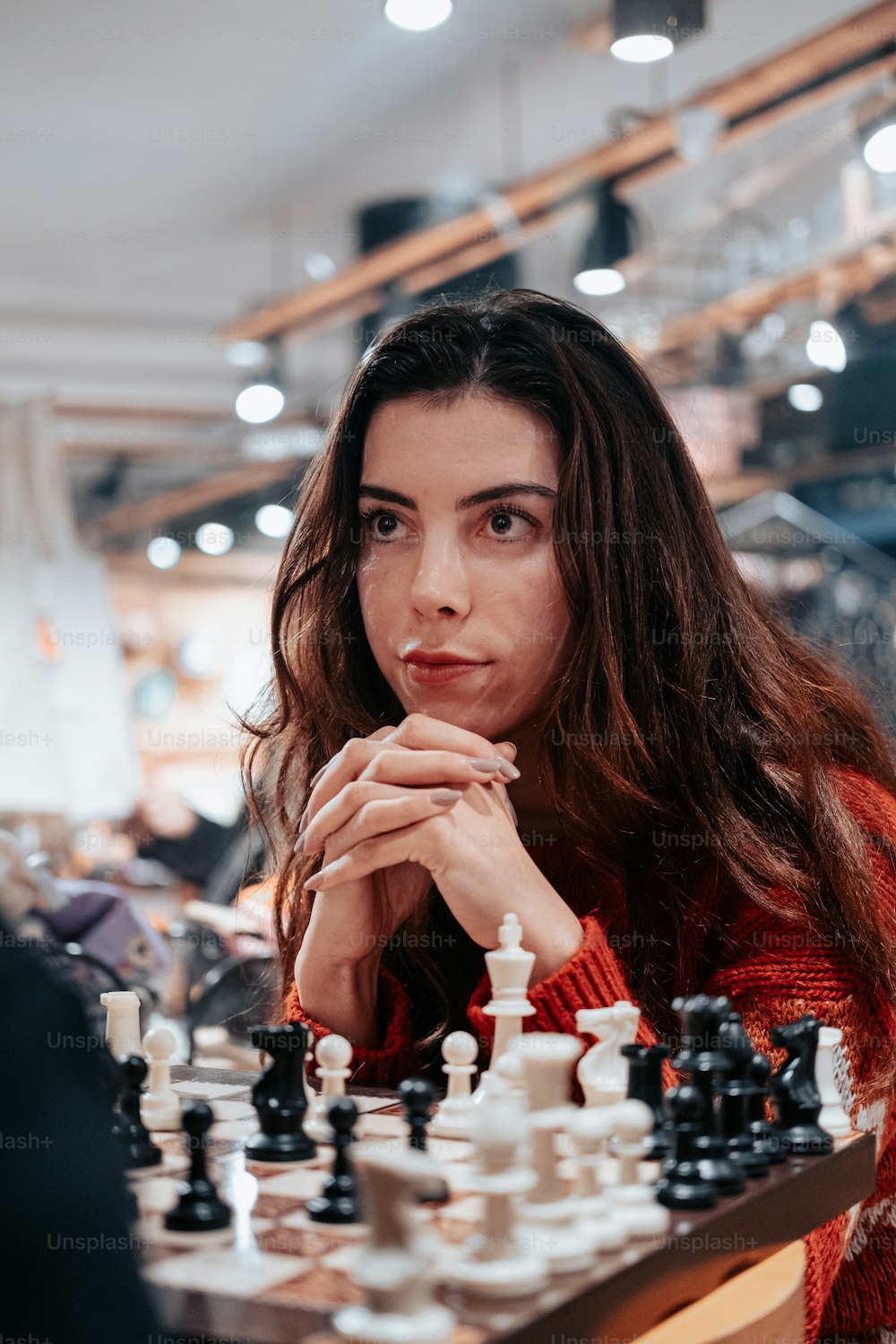a woman sitting at a chess board