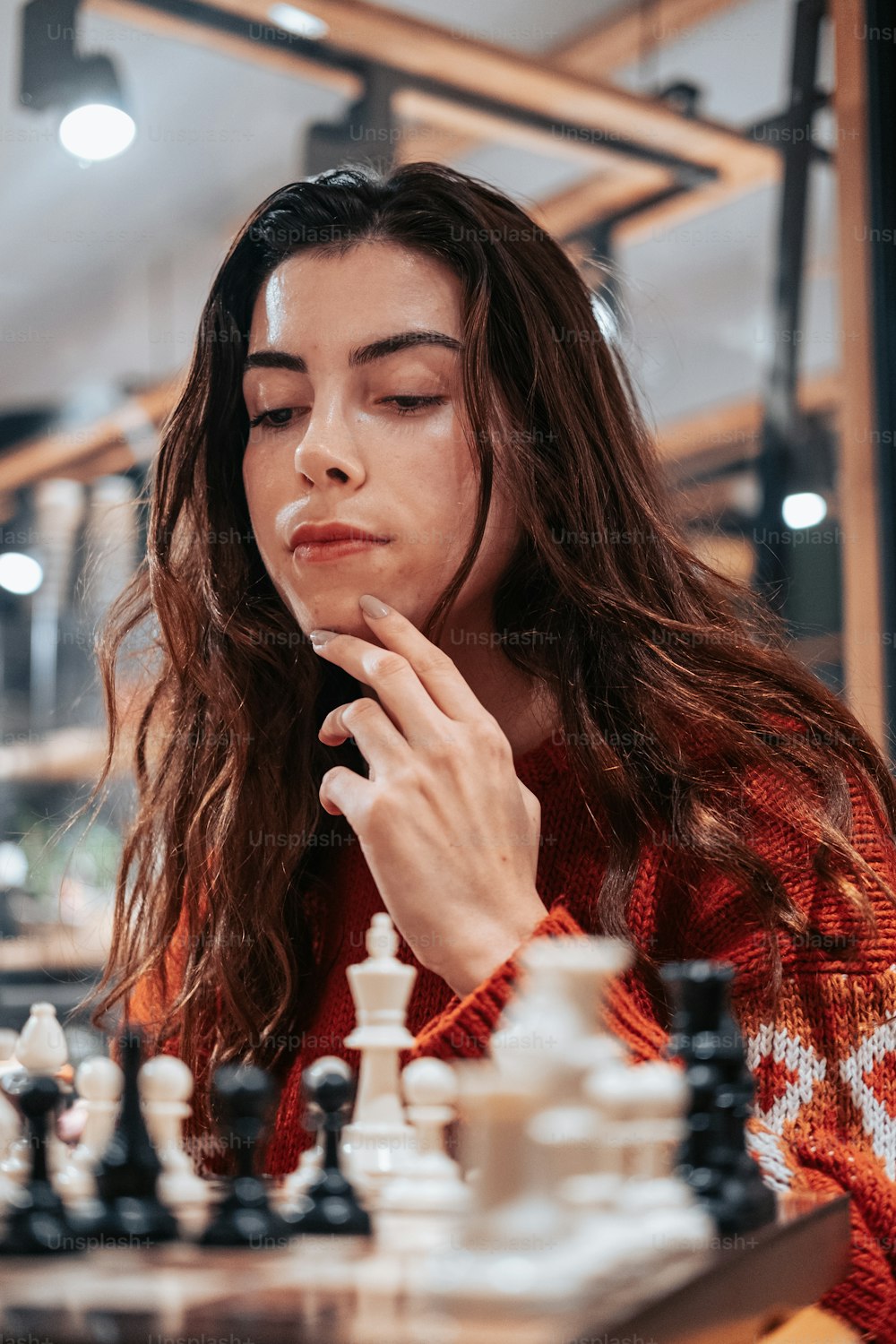 a woman sitting at a chess board