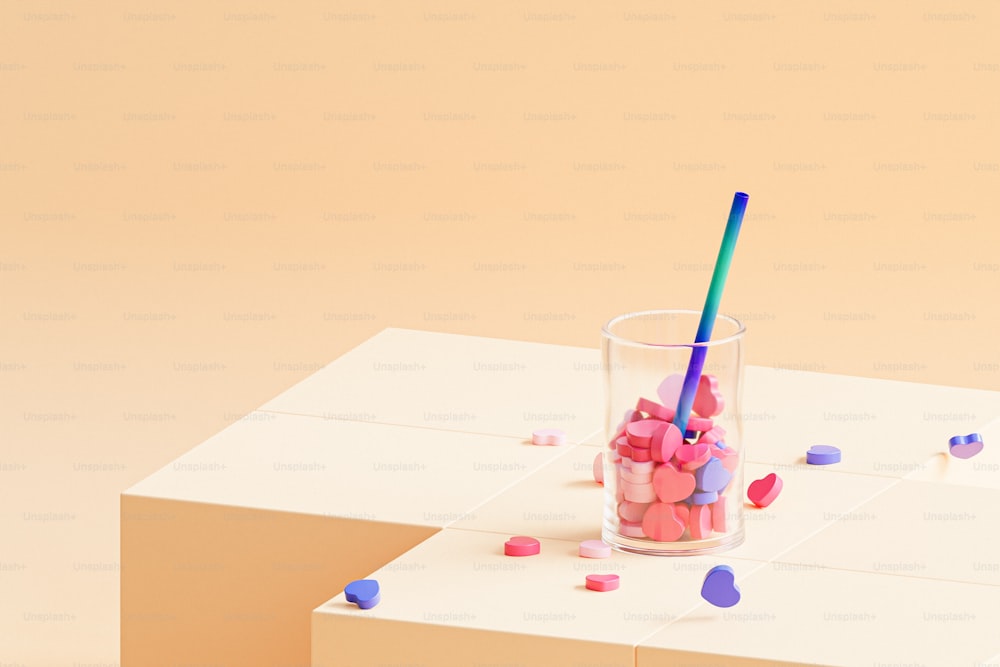 a cup with a straw and a straw on a table
