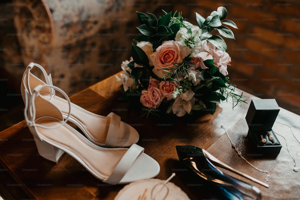 un paio di scarpe bianche con fiori su un tavolo