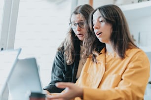 a few women looking at a computer