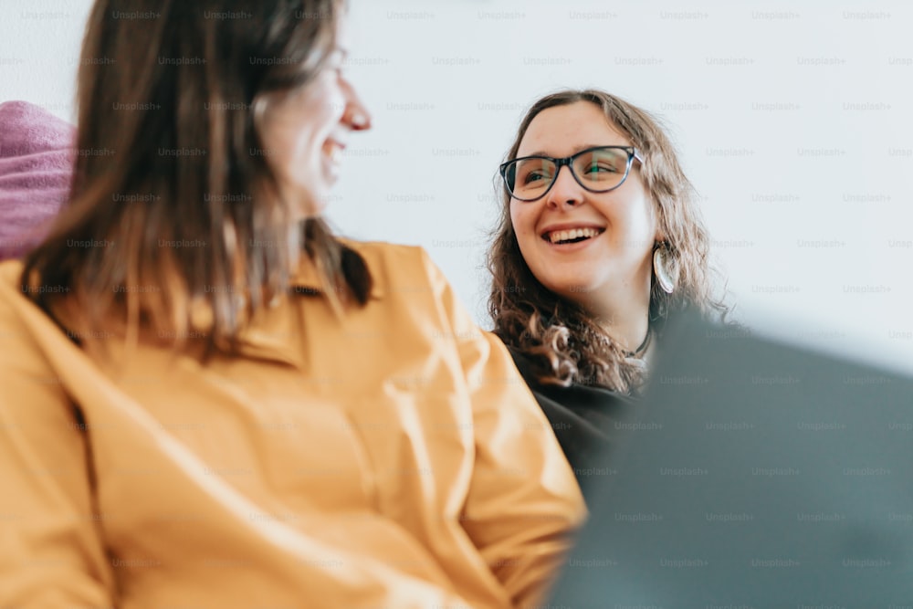 a person smiling at another woman