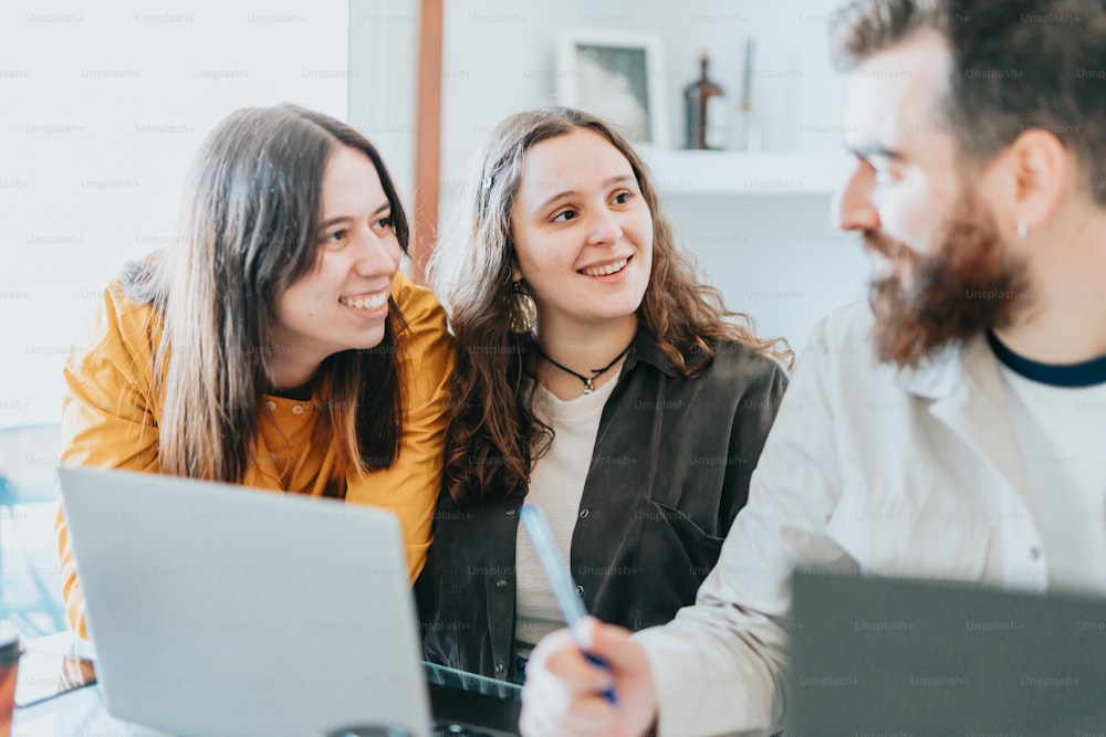 a group of people looking at a laptop