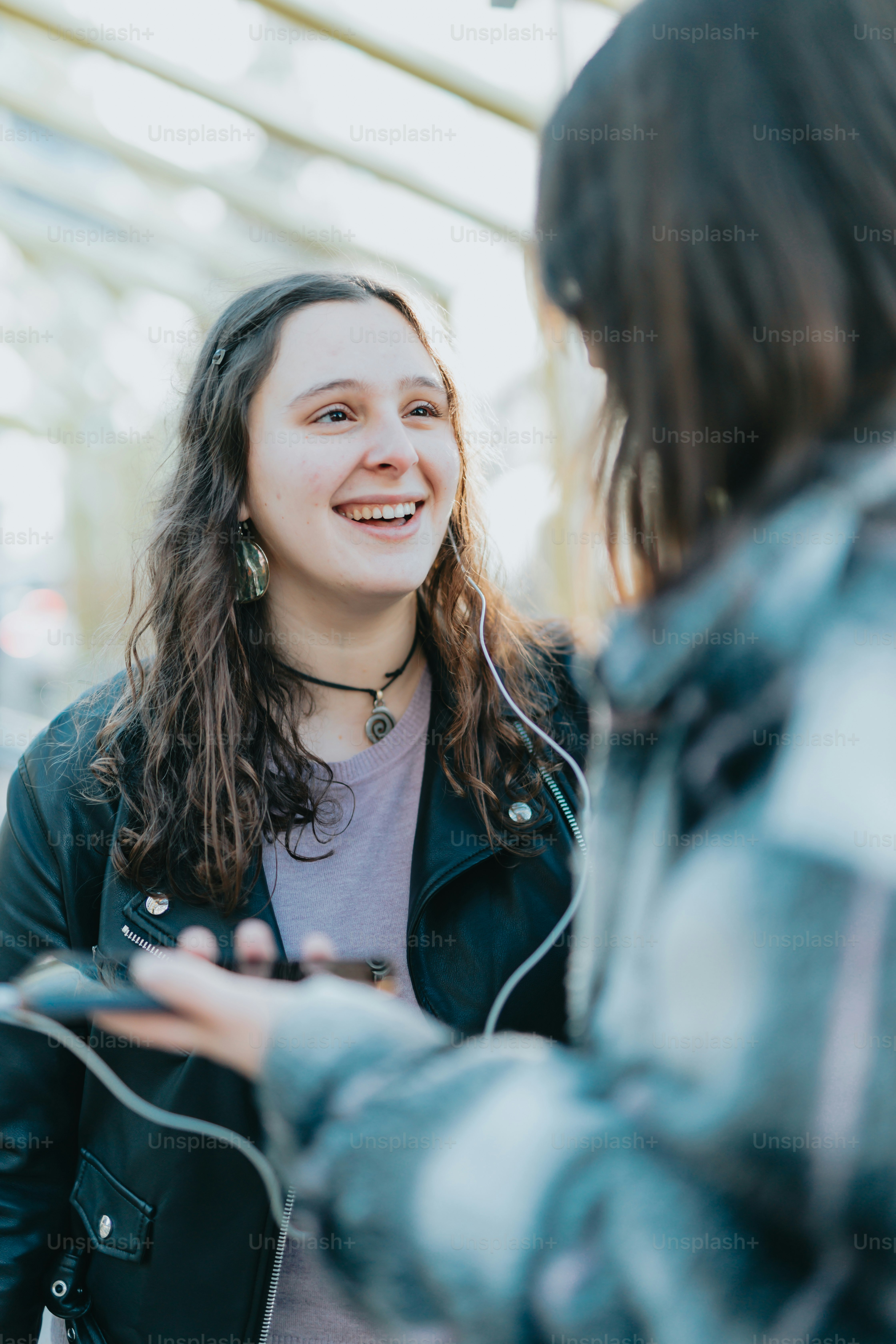a woman smiling and holding a bag