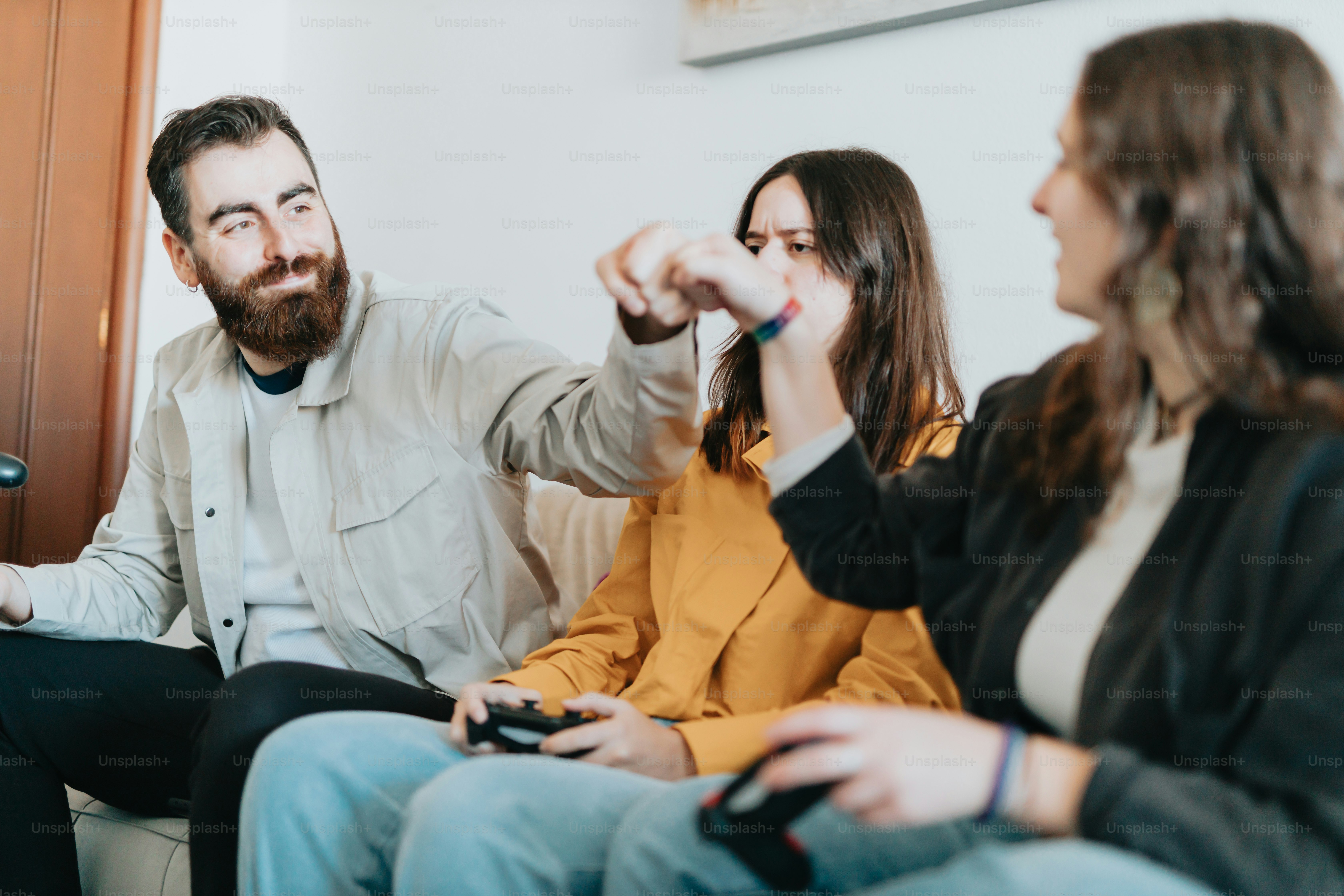 a group of people sitting and looking at a cell phone
