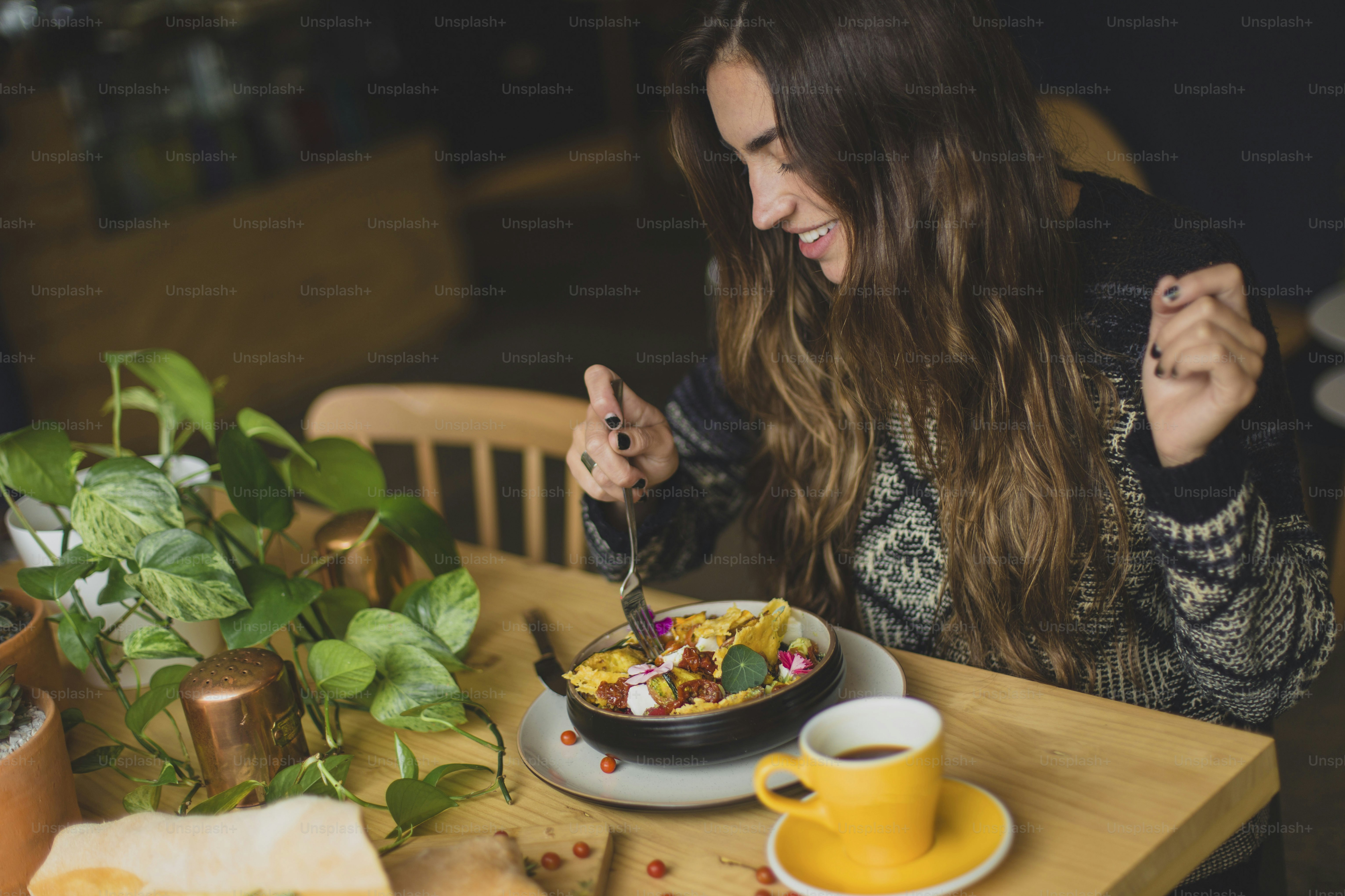 a woman eating food at a table
