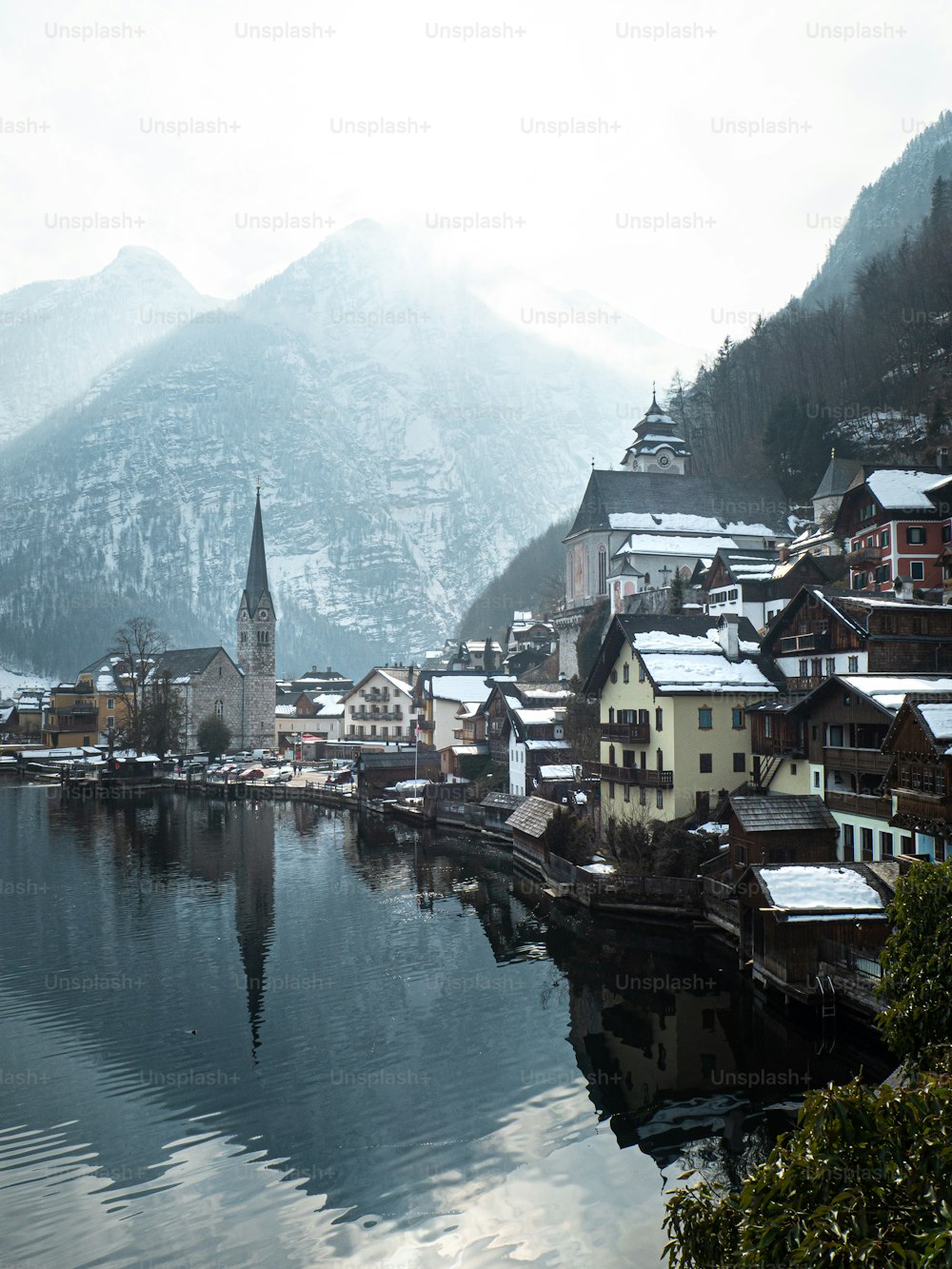 a town next to a river with Hallstatt in the background