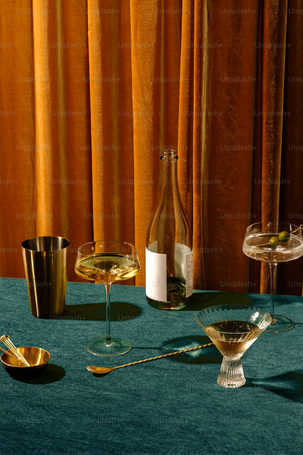 a table with glasses and candles