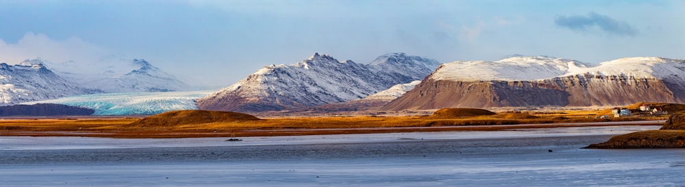 a body of water with mountains in the back