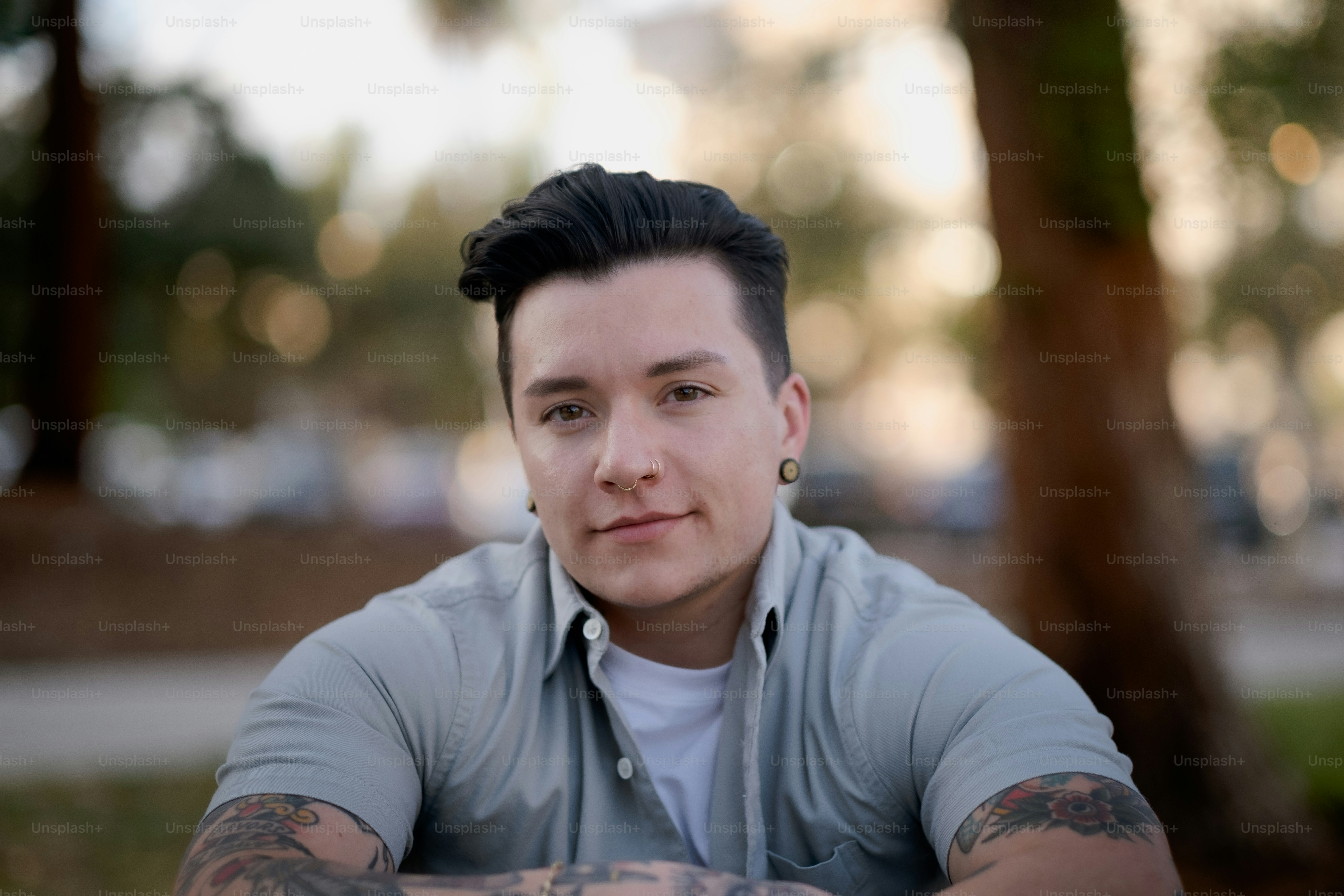 a man with tattoos smiling