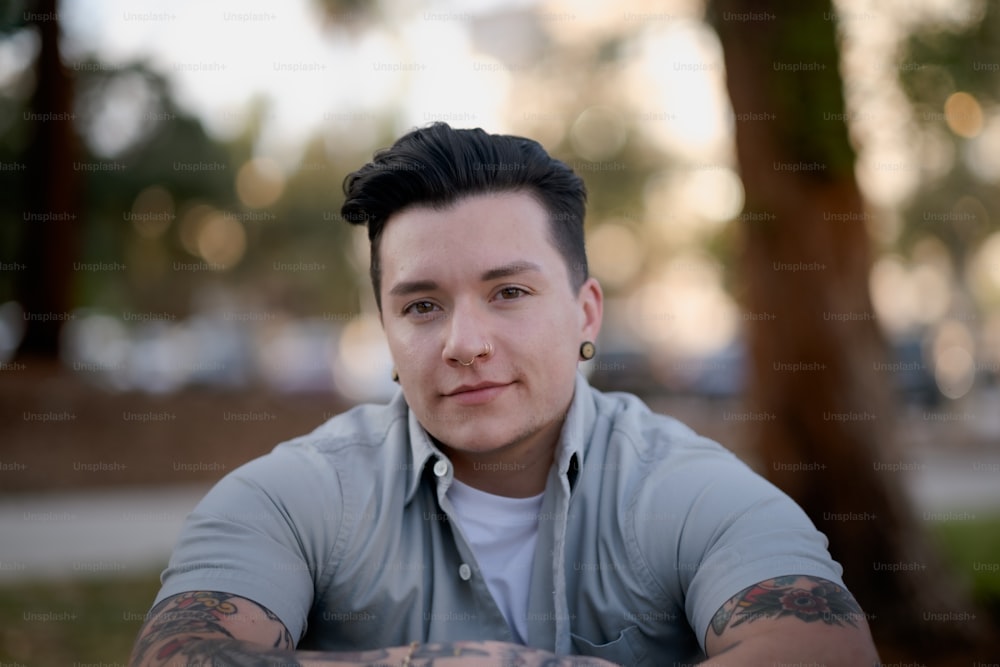 a man with tattoos smiling