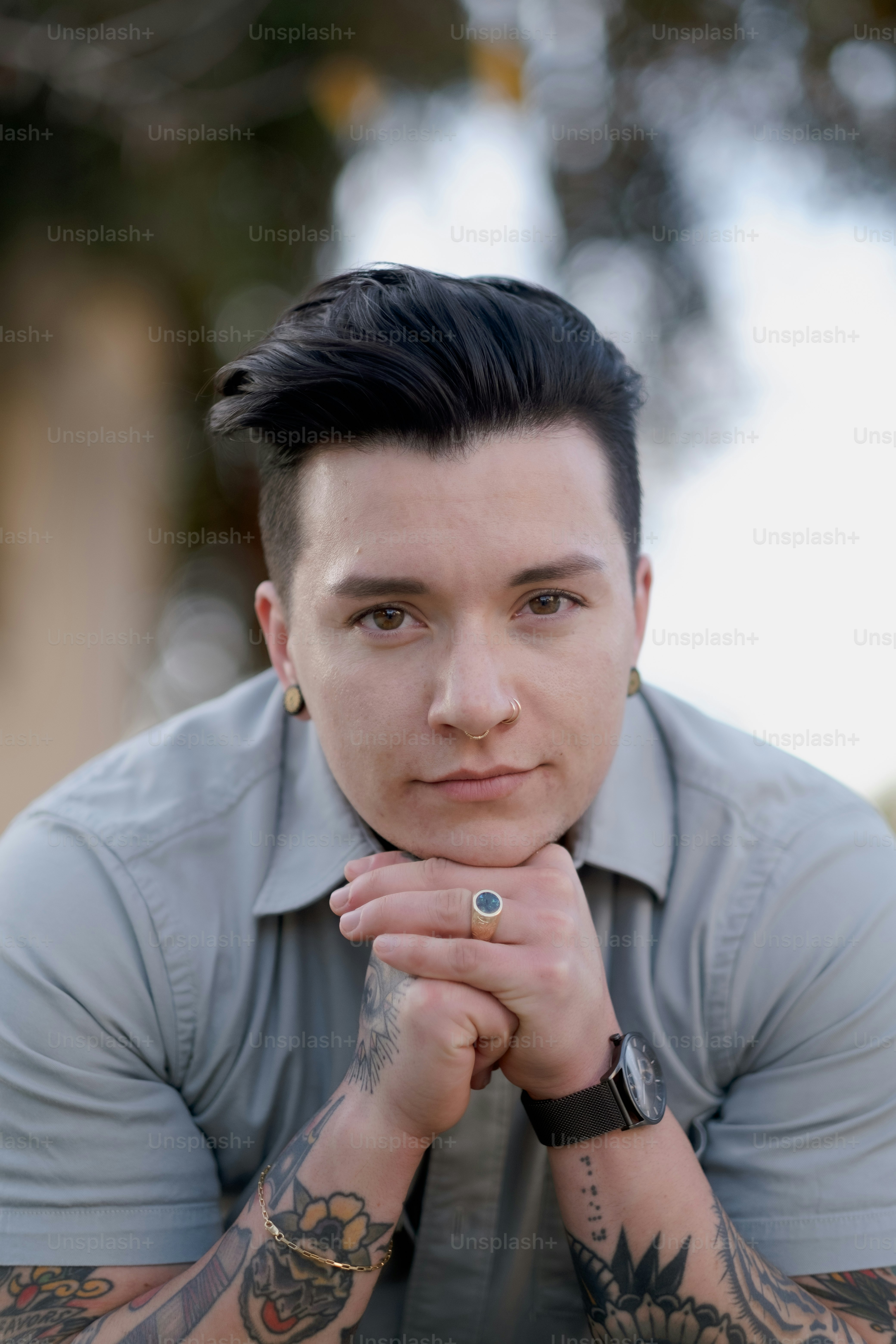 a man with tattoos and a watch