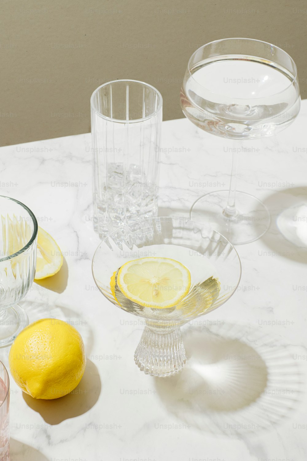 a group of glasses and lemons on a table