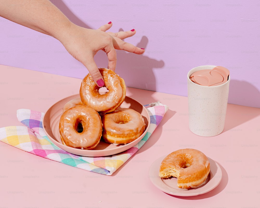 a person is holding a plate of donuts