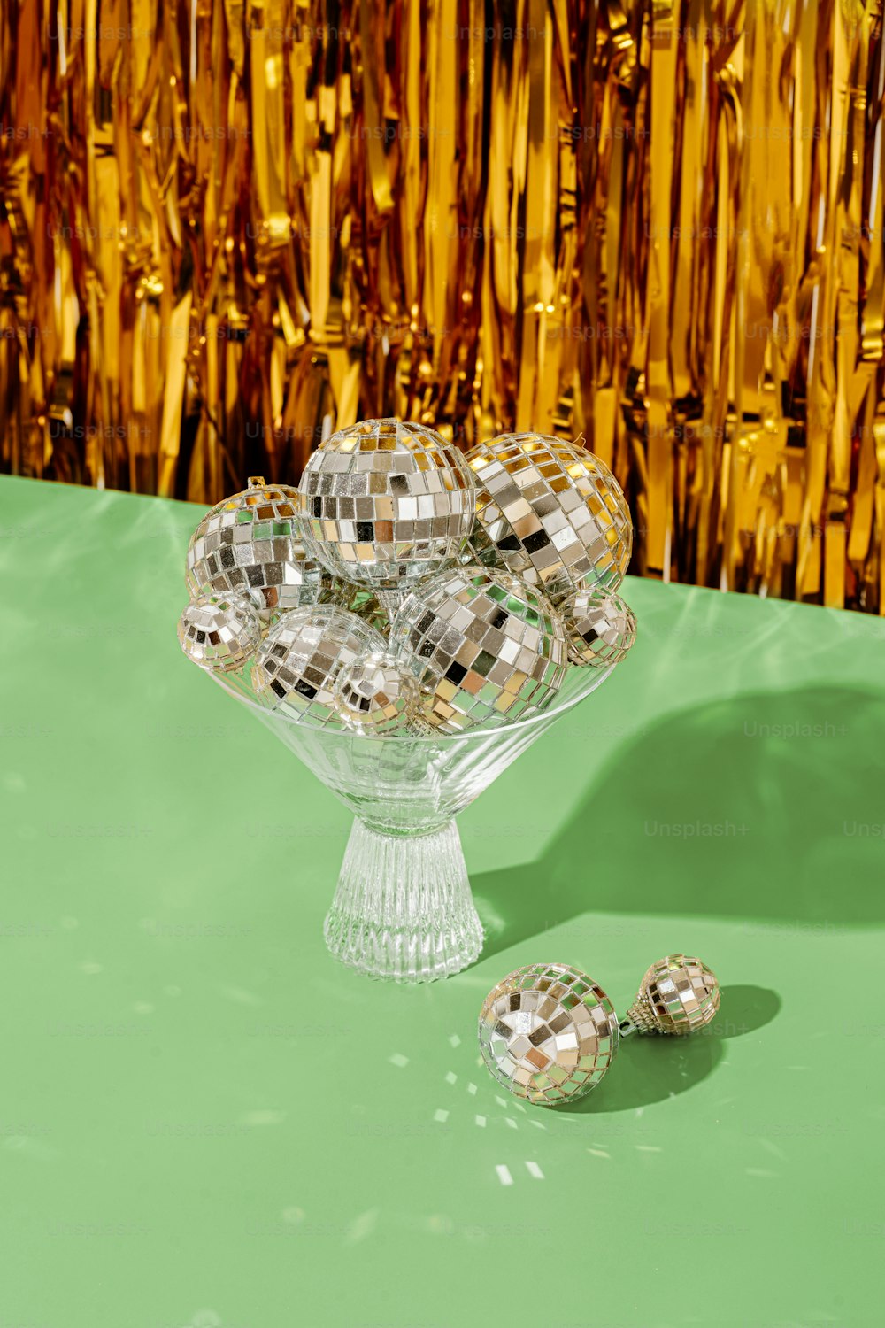a glass vase with silver balls