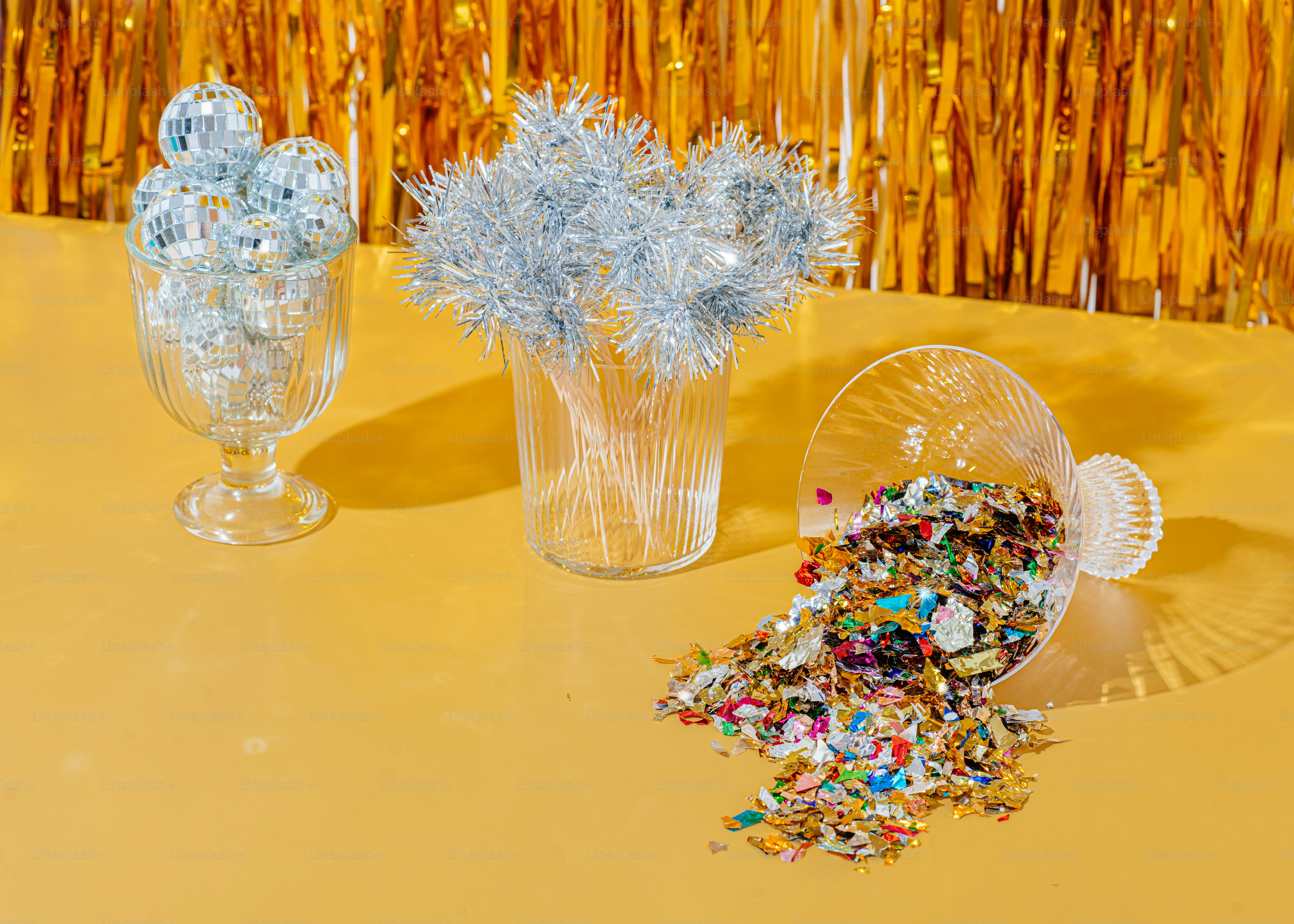 a couple of glass vases with flowers in them