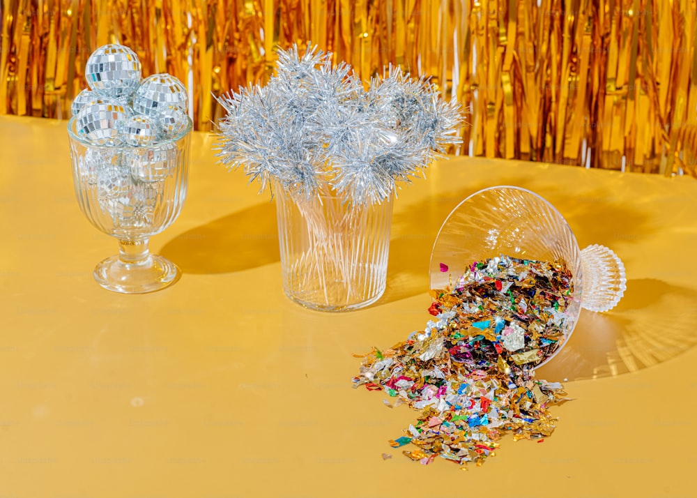 a couple of glass vases with flowers in them