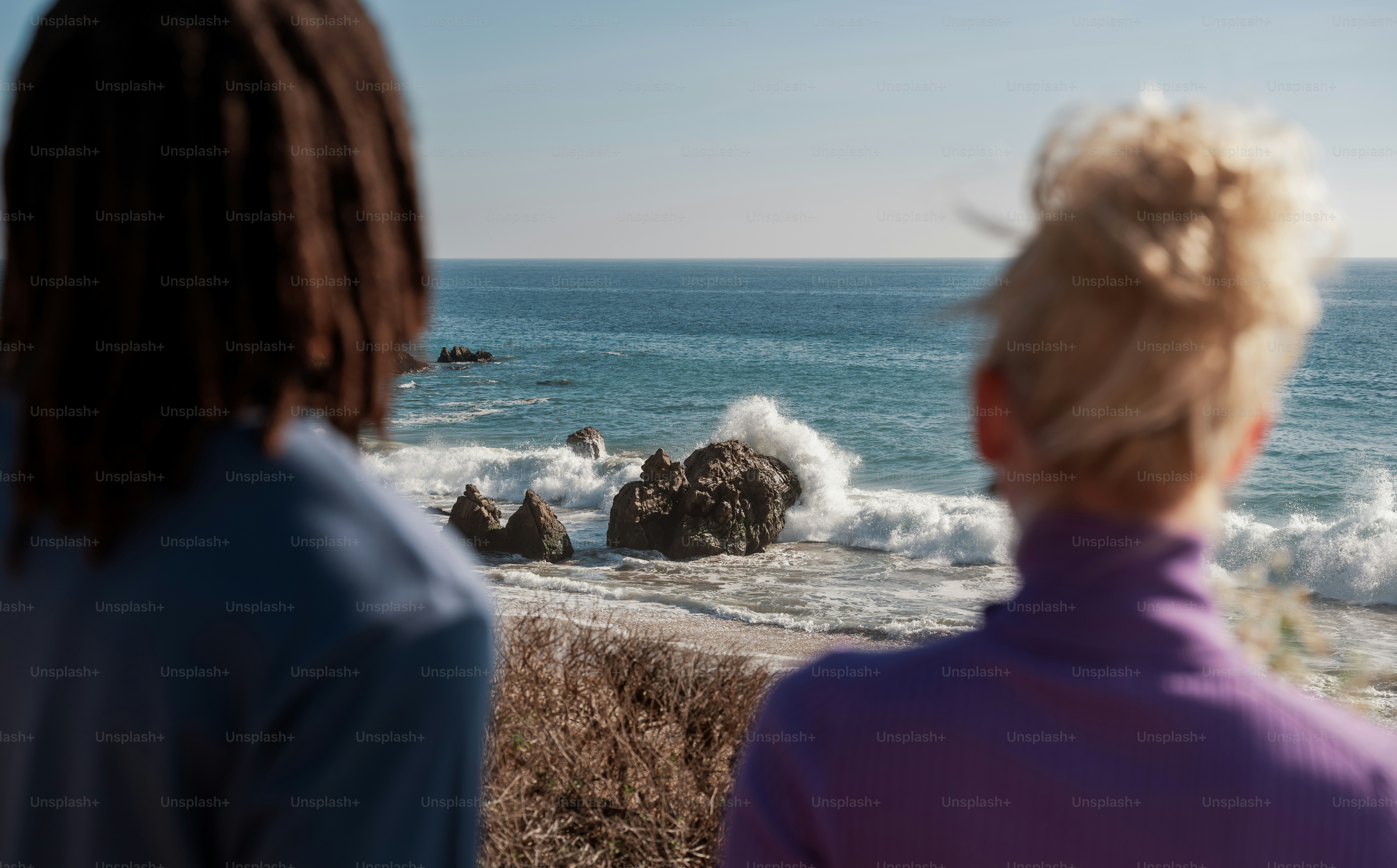 a group of people looking at the ocean