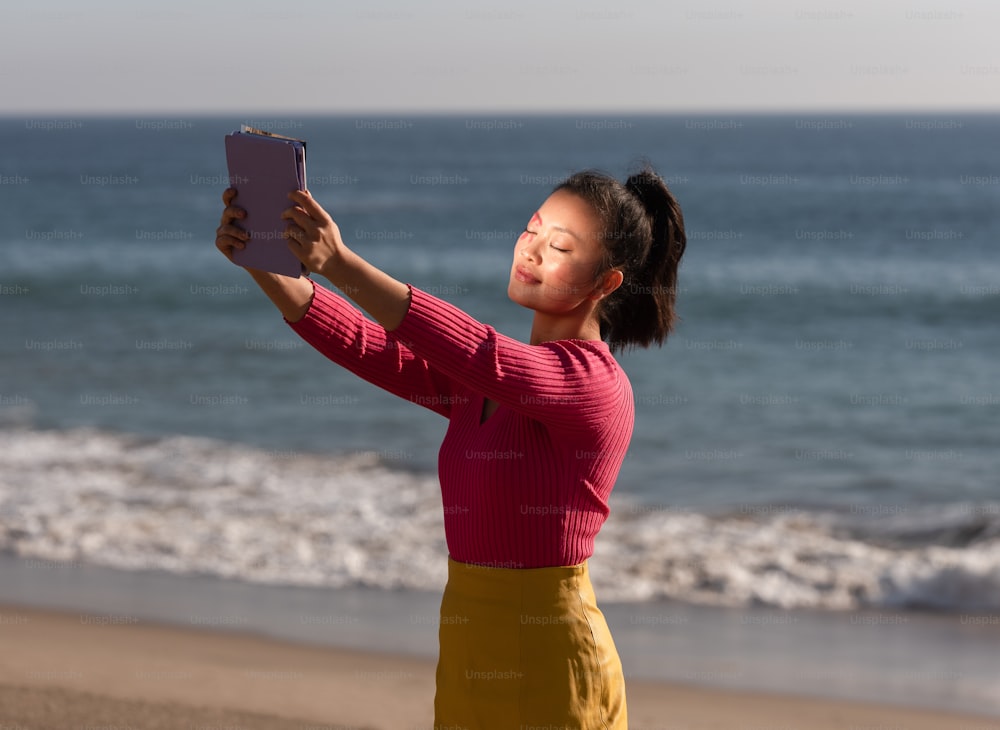 a person holding a phone on a beach