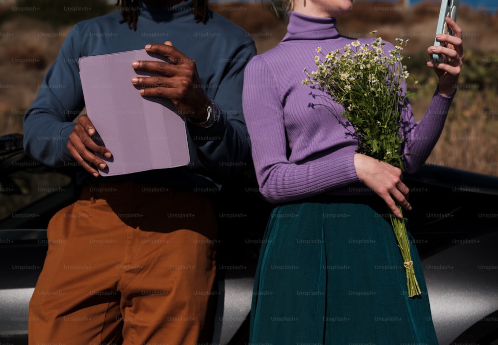 a couple of people holding flowers