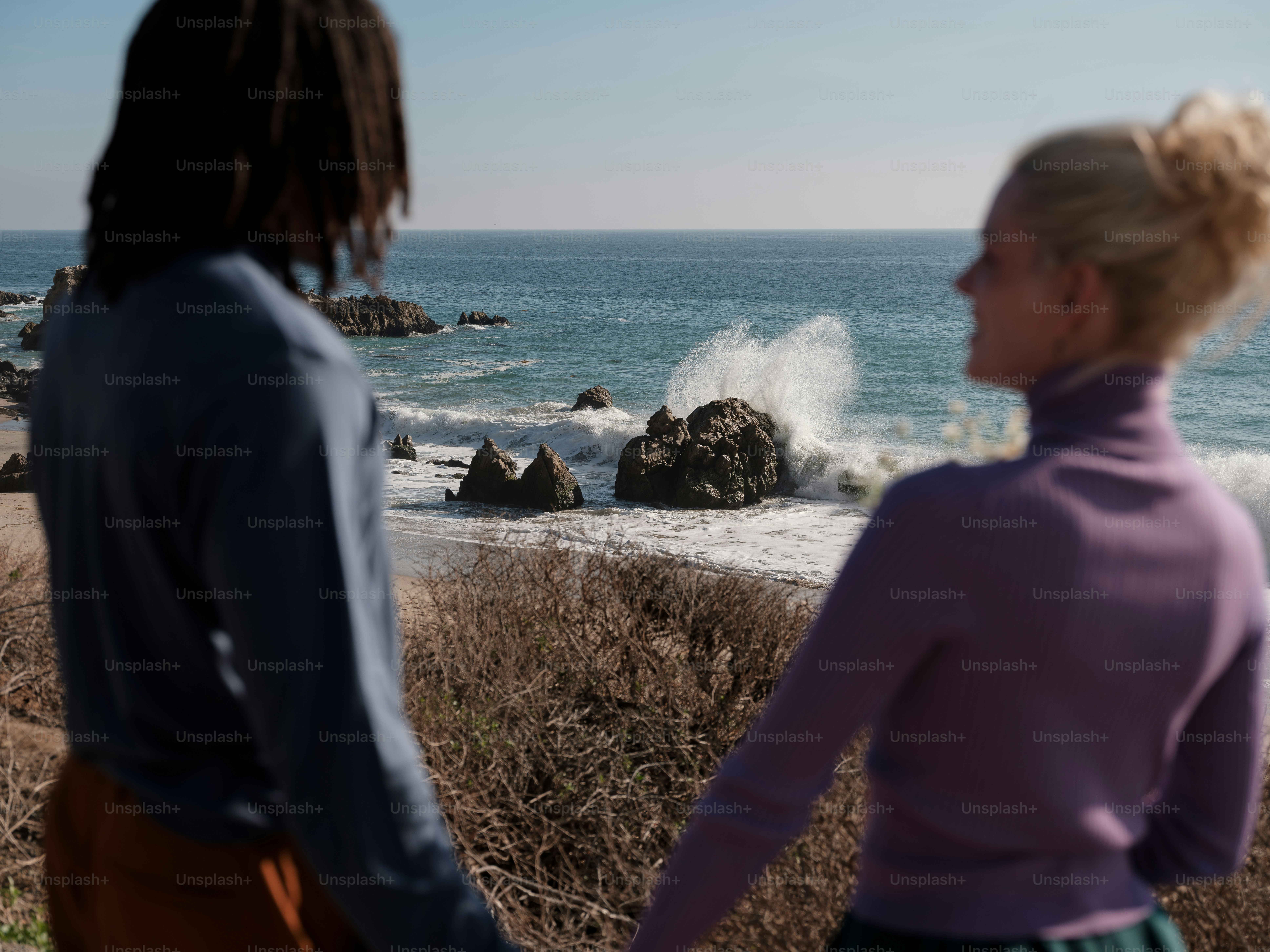 two women looking at the ocean