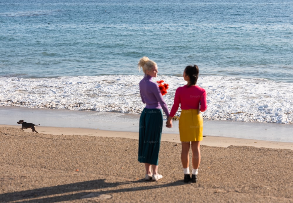 two women walking on a beach