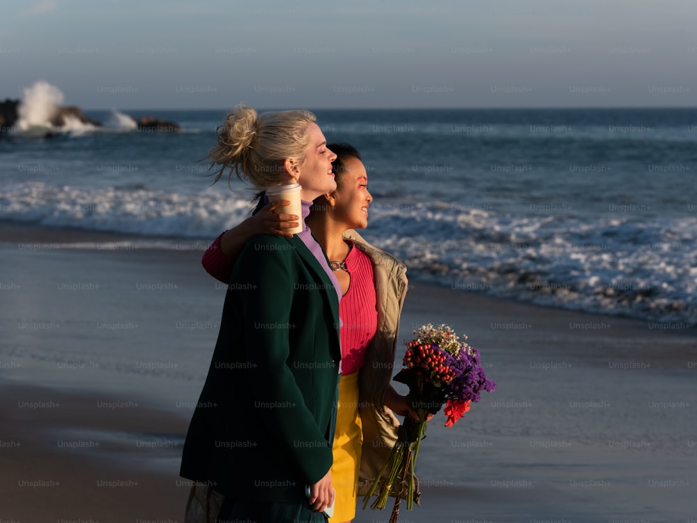 a man and woman kissing on a beach