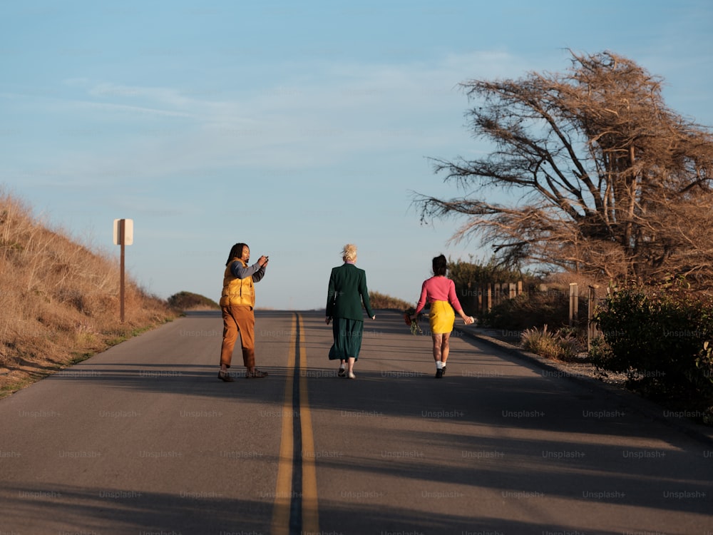 a group of people walking down a road