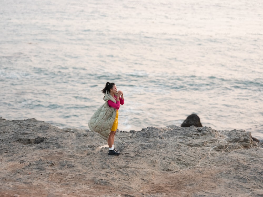 a person holding a baby on a beach