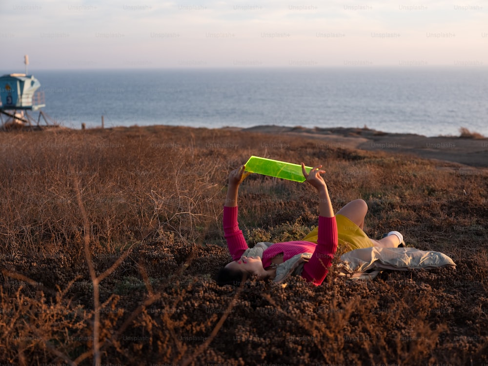 a person lying on the ground with a frisbee