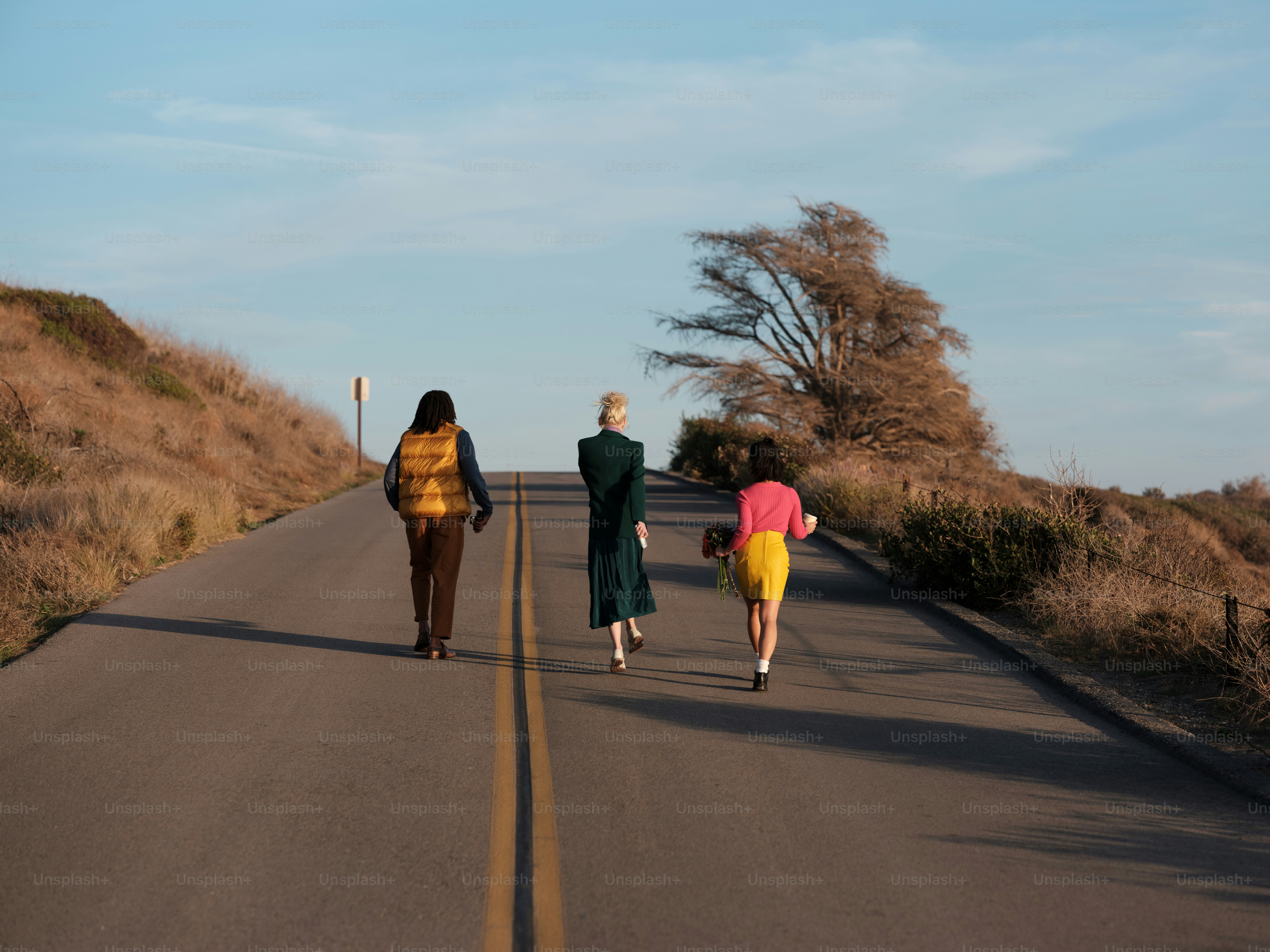 a group of people walking down a road