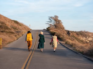 a group of people walking down a road