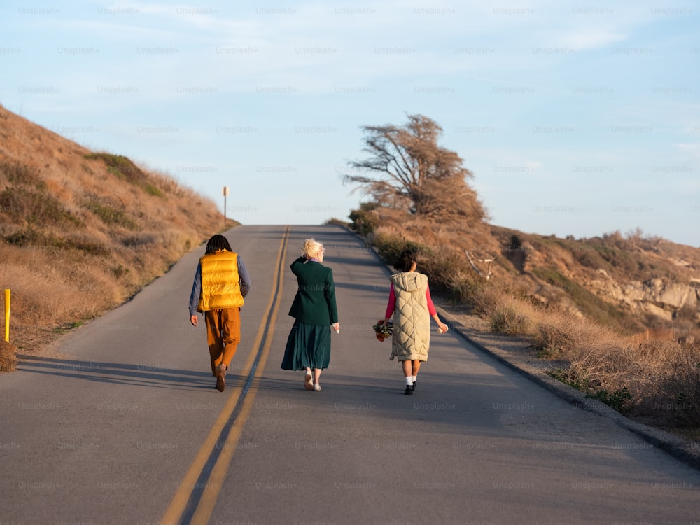 a group of people walking down a road