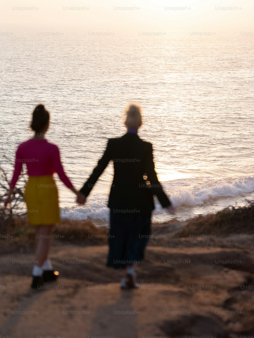a man and a woman walking on a beach