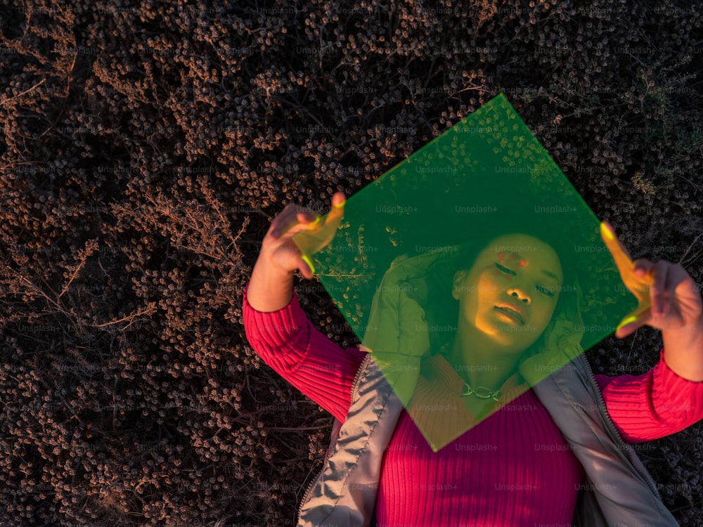 a person holding a green umbrella